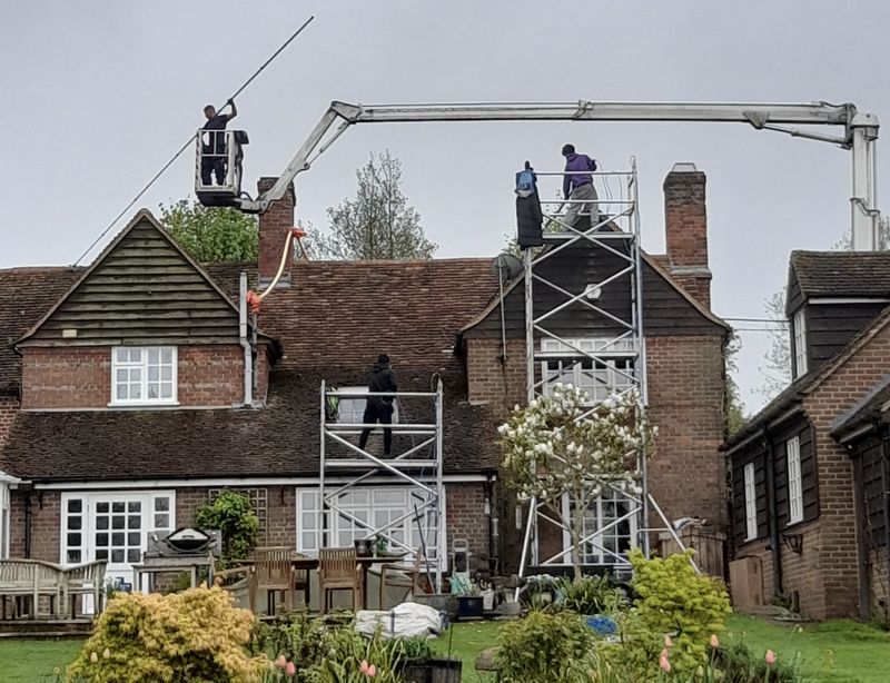 The Moss Cleaners using cherry picker and scaffolding to clean roof safely and professionally in Orpington, London